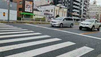 Osaka, Japan on September 29 2023. The habit of car drivers in Japan is to slow down their speed and even stop briefly at the location where the train tracks cross the road, there are no trains video