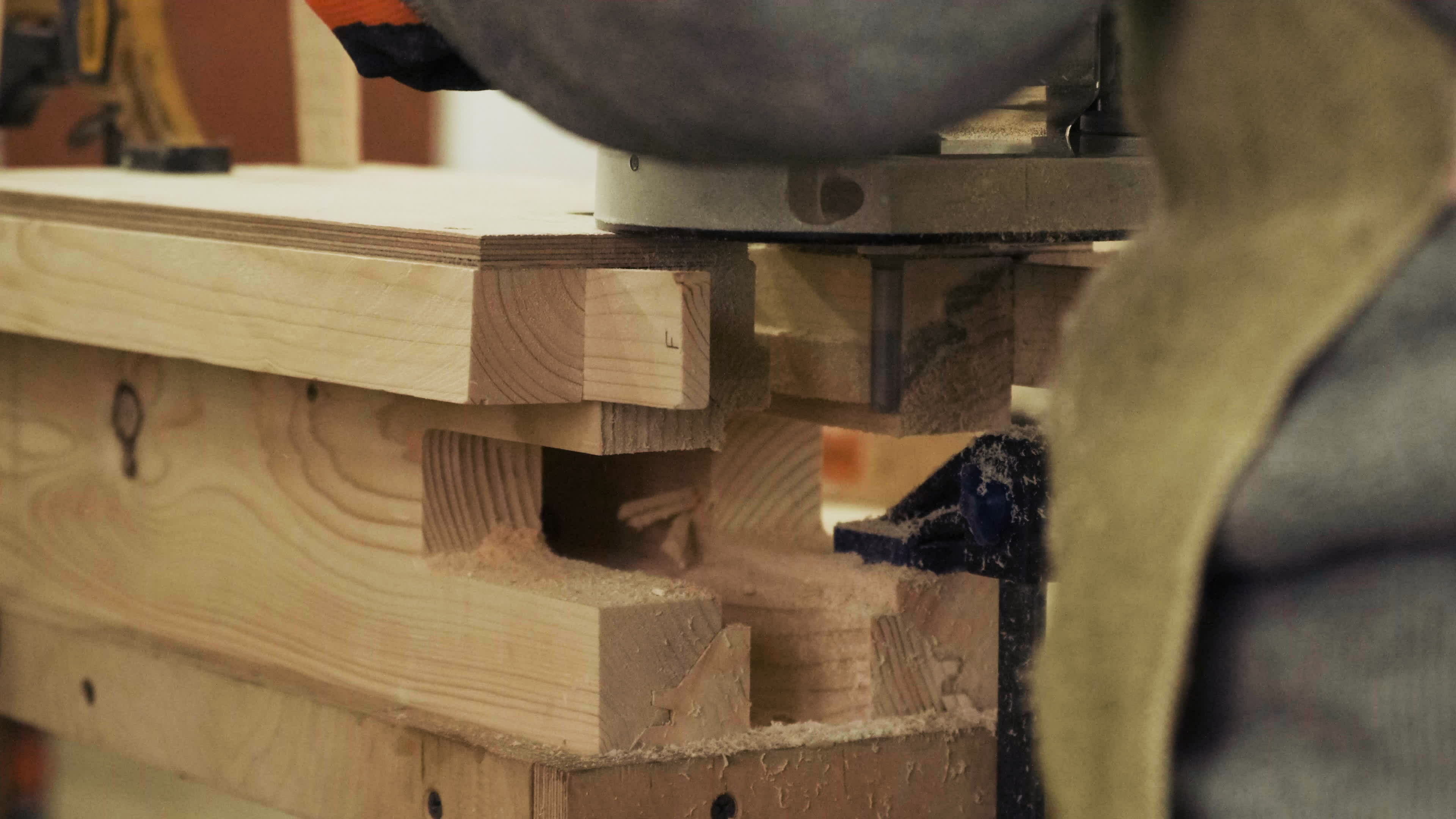 Carpenter working on manual hand milling machine in the carpentry