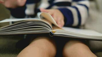 Slow motion boy reading a book video