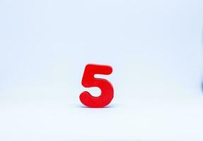 Red number five on white background photo