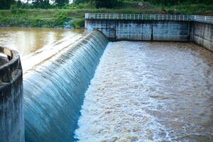 Water overflows from a weir caused by heavy rain in Thailand. photo