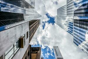 New York City buildings looking up with reflections. photo