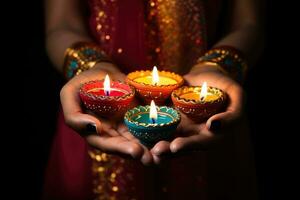 Woman hands with henna holding colorful clay diya lamps lit during diwali celebration. AI Generative photo