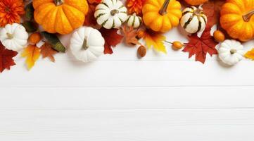 Autumn decor from pumpkins and leaves on a white wooden background. Flat layout autumn theme with copy space photo