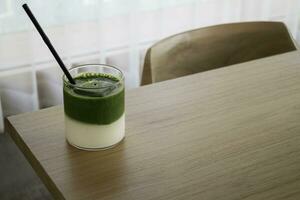 Iced matcha greentea on wooden table photo