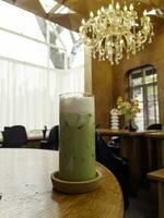 Iced matcha greentea on wooden table photo