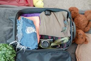 arrangement of clothes and accessories in a suitcase,Travel concept. photo