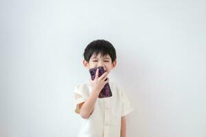 Asian boy Wear traditional Thai clothing Talk on the phone on a white background photo