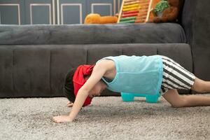 Asian boy in tank top doing exercise And there was a sweat towel on his head. photo