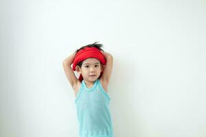 Asian boy in tank top doing exercise And there was a sweat towel on his head. photo