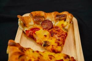 slice of pizza cheese lunch or dinner crust seafood meat topping sauce. delicious tasty fast food in side view. photo