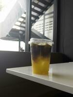 A glass of iced black orange coffee photo