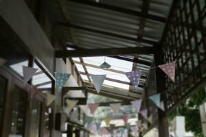 Festive colorful flags decorated on wooden architecture photo