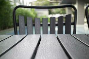 Empty table top and blurred swimming pool in tropical resort photo