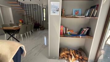 Interior of a modern living room with bookshelves and chairs photo