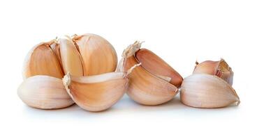 Fresh garlic bulb with cloves in stack isolated on white background with clipping path photo