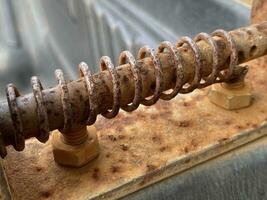 old metal rusty screw with a bolt in a workshop, selective focus, macro photo