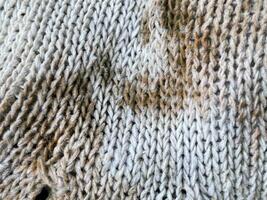 texture of a knitted fabric, a background of a white wool with a pattern of wool photo