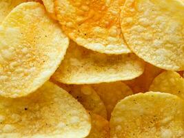 crispy potato chips in a bowl. top view. photo