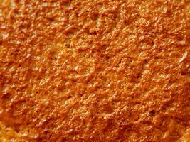 texture of the orange sponge cake, closeup photo