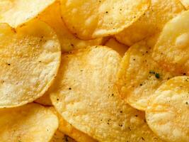 crispy potato chips in a bowl. top view. photo