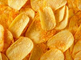 crispy potato chips in a bowl. top view. photo