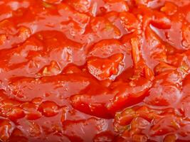 red tomato sauce with garlic in pan photo