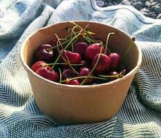 a bowl with fresh cherries on the street picnic photo