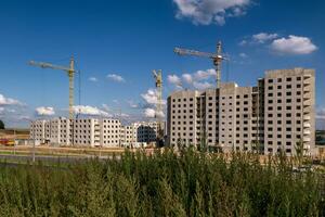 tower cranes on construction site, providing housing for low-income citizens of third world countries photo