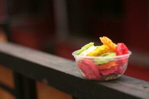 Colorful Kerupuk Kembang Mawar Mentah or Raw Rose Crackers on transparent box photo