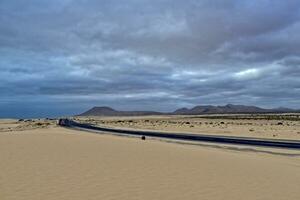 landscape from the Spanish Canary Island Fuerteventura with dunes and the ocean photo