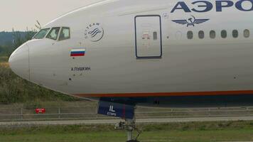 MOSCOW, RUSSIAN FEDERATION JULY 29, 2021 - Widebody plane Boeing 777 of Aeroflot taxiing at Sheremetyevo airport. Airplane on runway, side view video