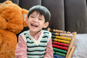 Asian boy smiling and laughing happily lying on bed photo