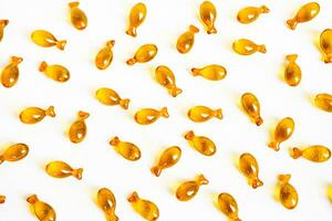 Omega 3 oil capsules shaped fish. Nutrition supplement for support health. photo