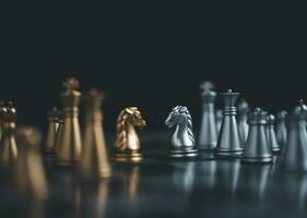 Gold and silver chess pieces in chess board game for business comparison. Leadership concepts, human resource management concepts. photo