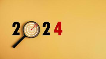 The dartboard icon in a magnifying glass centered on the number 2024 on a yellow background. Represents the goal setting for 2024, the concept of a start. financial planning development strategy photo