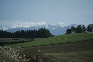 clouds over the mountains and farms photo