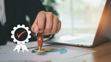 Businessman hand using wooden stamping to document approve and reject document or project, Signing a business contract approval of contract documents confirmation, approval stamp, copy space. photo