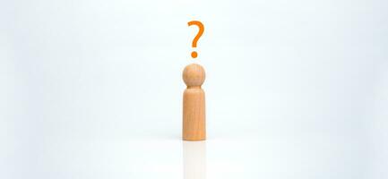A wooden doll with a question mark represents thinking. Conceptual decisions, business selection concepts, ideas for finding business answers, business future decisions. photo