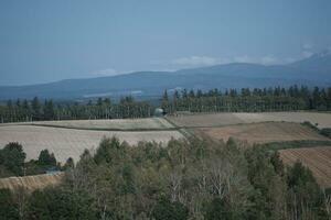 clouds over the mountains and farms photo