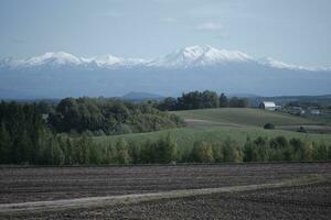 clouds over the mountains and farms photo