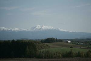 clouds over the mountains and farms photo