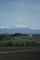 clouds over the mountains and farms photo