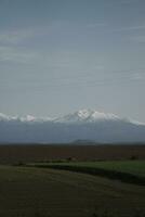 clouds over the mountains and farms photo