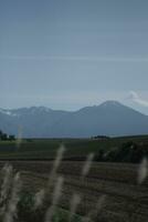 clouds over the mountains and farms photo