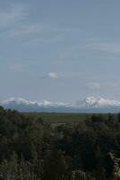 clouds over the mountains and farms photo