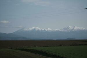 clouds over the mountains and farms photo