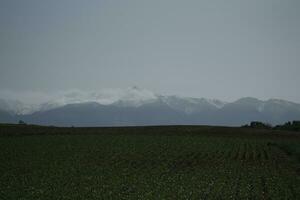 clouds over the mountains and farms photo