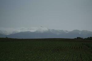 clouds over the mountains and farms photo