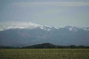clouds over the mountains and farms photo